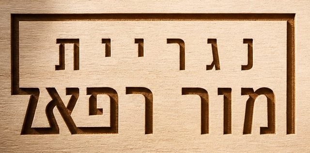 הלוגו של נגריית מור רפאל, חרוט בעץ